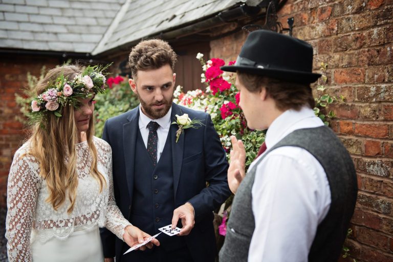 Magician Darren Campbell doing his magic trick to bride and groom at Overbarn, Gloucester.