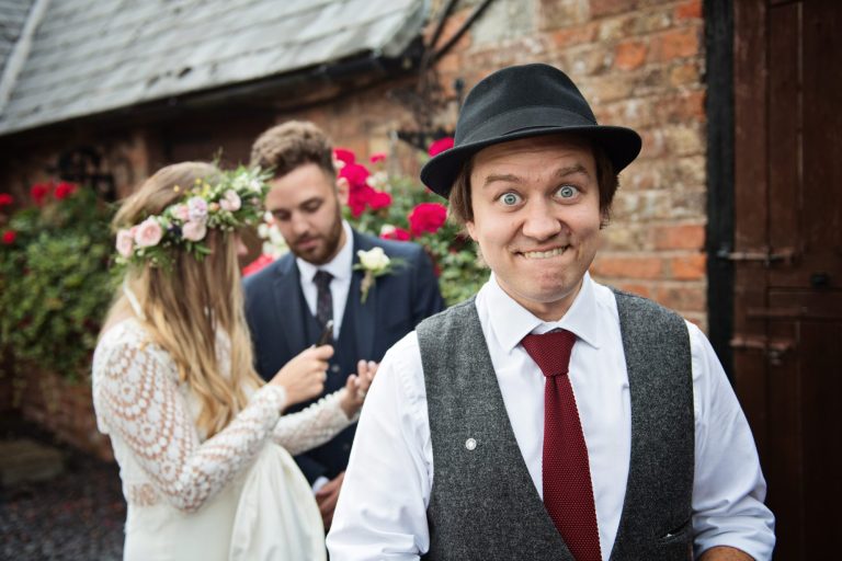 Magician Darren Campbell doing his magic trick to bride and groom at Overbarn, Gloucester.