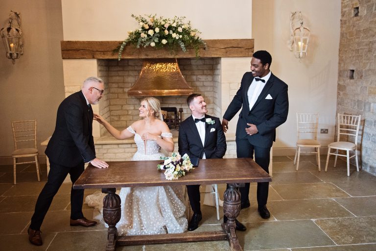 Bride and groom getting congratulated by their witness's. Candid photo by Blooming Photography taken at Blackwell Grange.