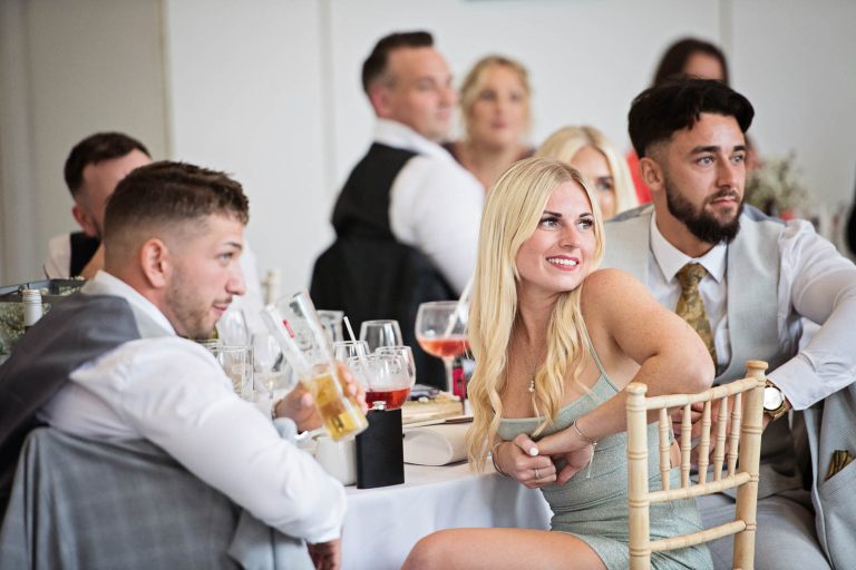 Natural photo taken of wedding guests, during the wedding speeches at Margam Country Park