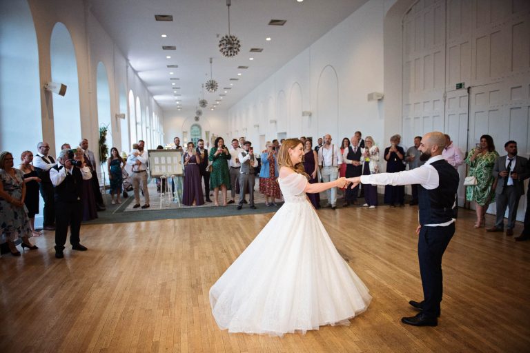 Colour photo of bride and groom doing their first dance in the Orangery at Margam Country Park