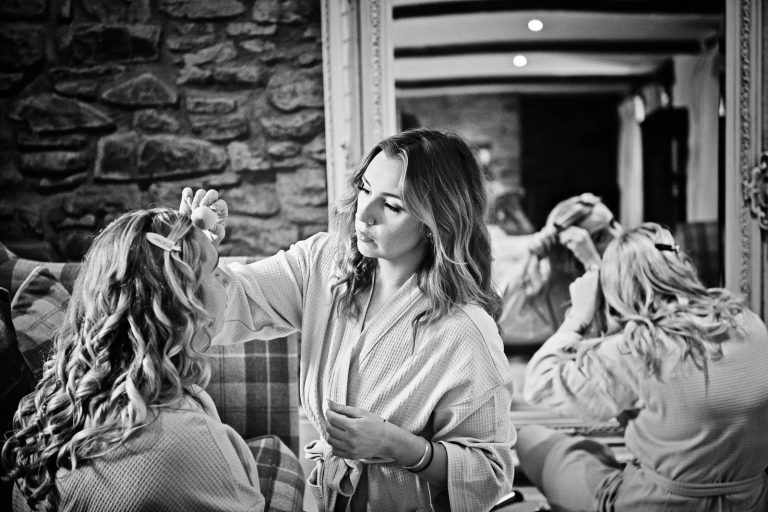 Stunning black and white image of bridesmaids getting ready. By Cardiff wedding photographer, Blooming Photography