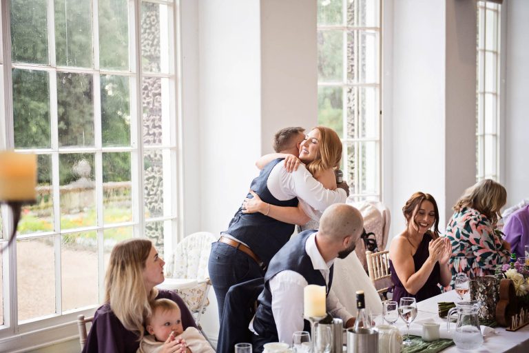 Natural image of bride hugging bestman taken during the wedding speeches.