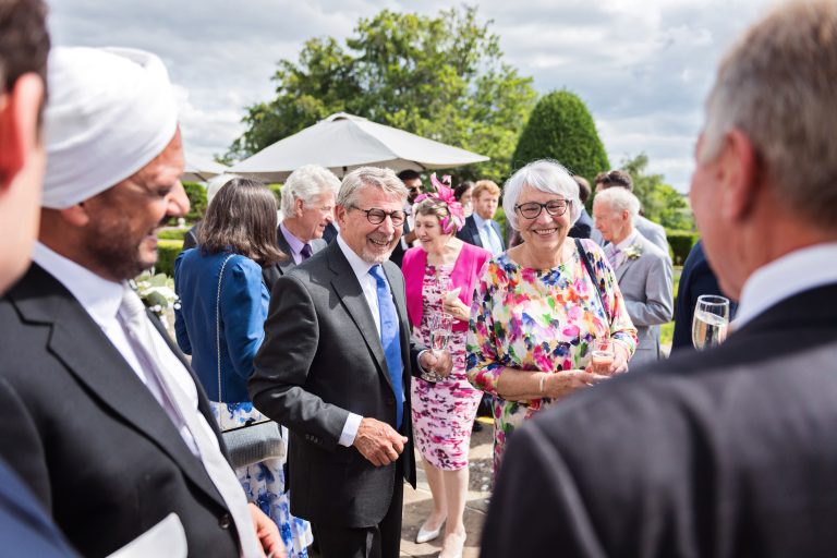 Guests chat candidly in the courtyard of Danesfield House Hotel and Spa. Photography by Ben Roberts Blooming Photography.
