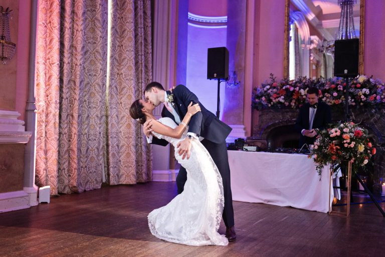 Bride and groom do their first choreographed dance including a successful "wedding dip". Photographed in the elegant Danesfield House Hotel and Spa Ballroom.