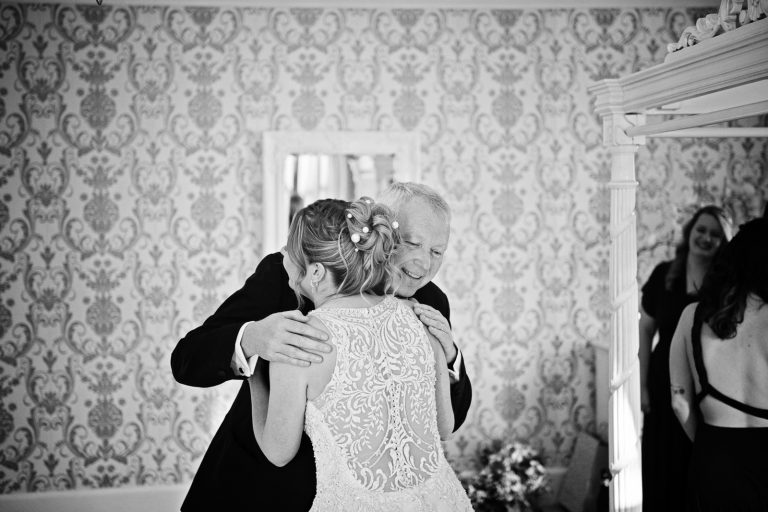 B&W photo of the brides father hugging his daughter (aka the bride). Captured at Eastington Park.