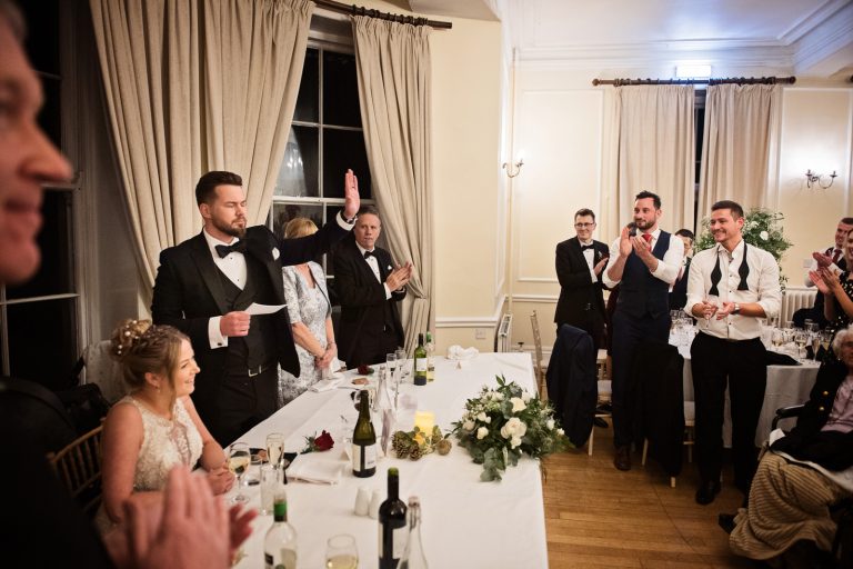 Groom delivers his wedding speech in front of the wedding guests. Photograph by Blooming Photography taken at Eastington Park at Christmas Wedding.