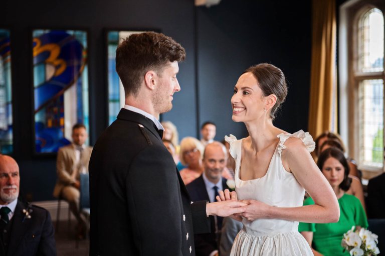 Ring exchange between husband and wife at Winchester registry office. Photo by Blooming Photography