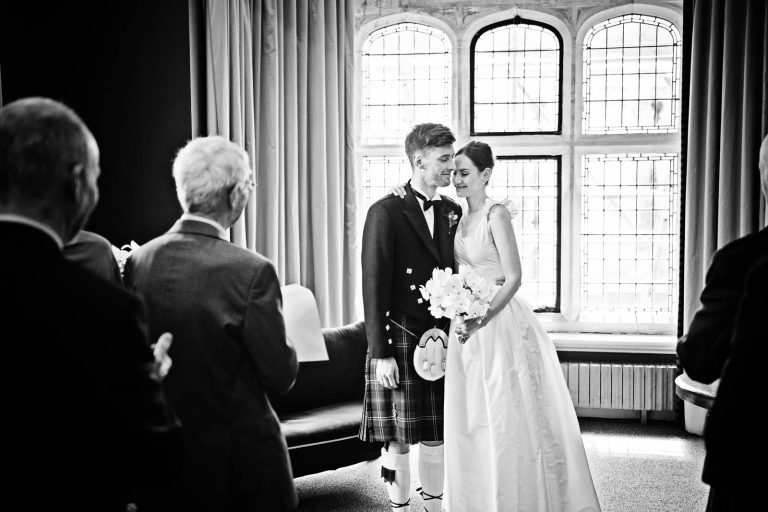 Timeless wedding b&w photo of a bride and groom at Winchester registry office. Photo by Blooming Photography