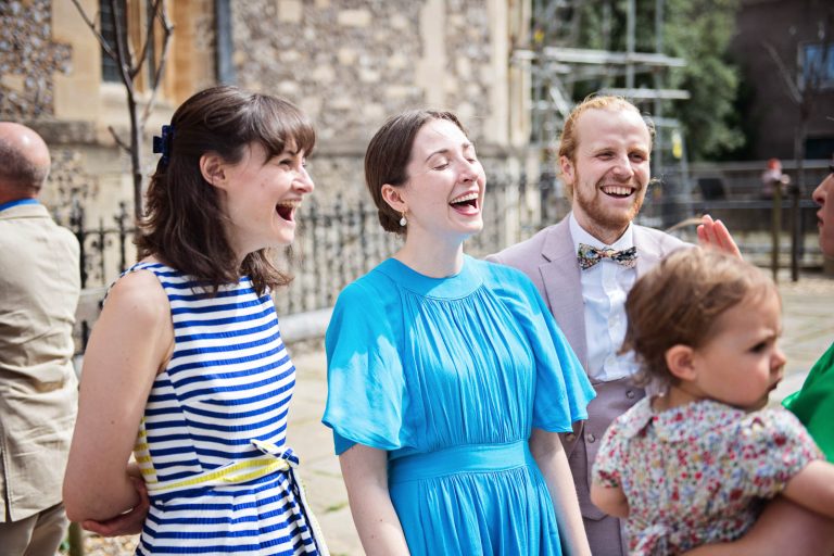 Natural wedding moments captured candidly of people laughing, photo by Blooming Photography
