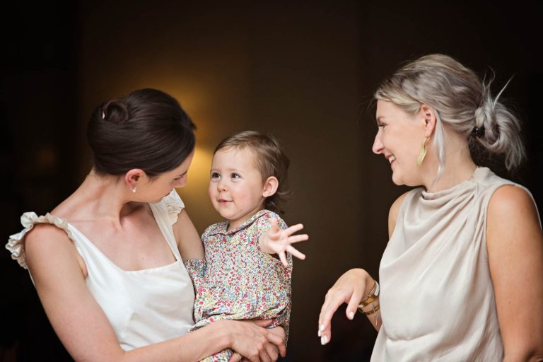 Bride with flower girl laughing with another guest, photograph taken at Hotel du Vin, Winchester by Blooming Photography
