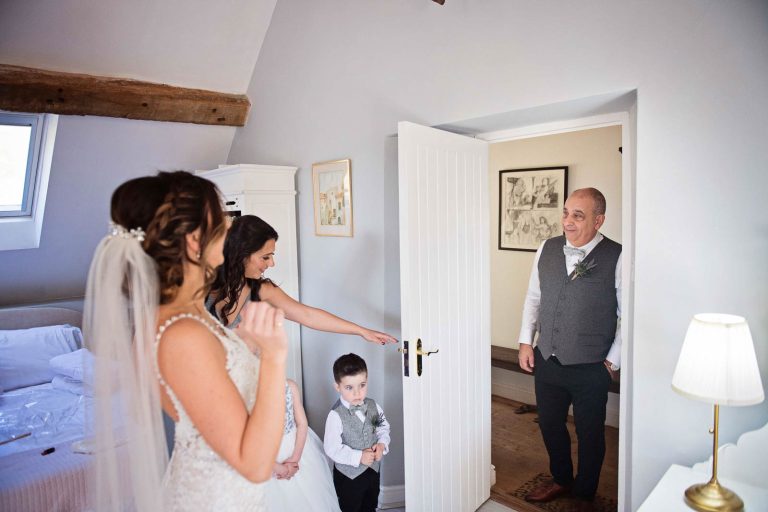 Storytelling image of dad seeing his daughter for the first time at Owlpen Manor.