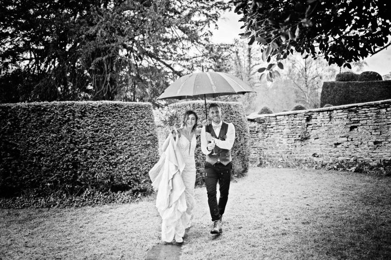 Bride and groom during a shower. B&W photo.