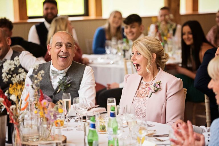 Mother of the bride laughing out loud. Candid photo.