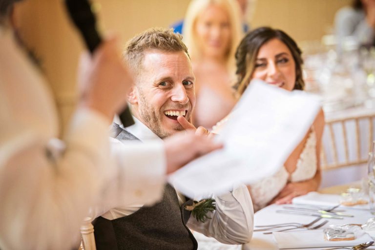 Groom biting his fingers during the wedding speech.