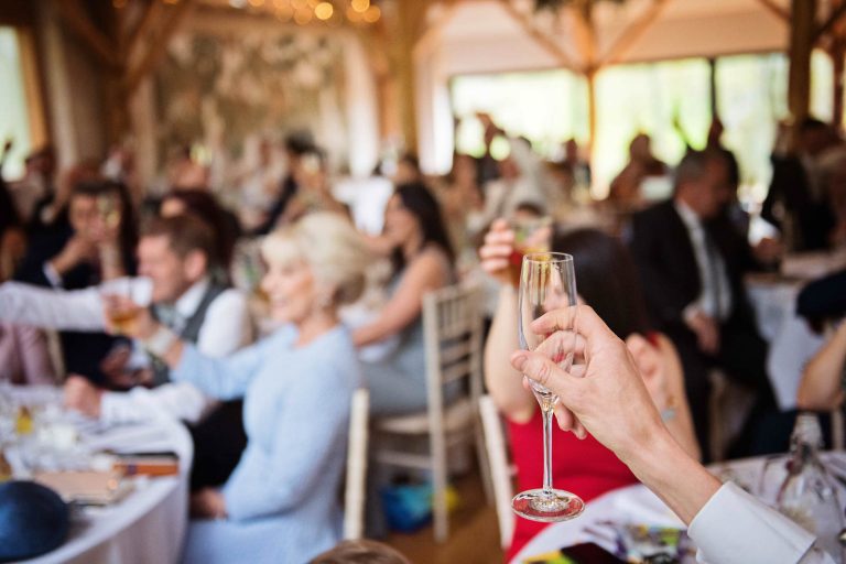 Raising a glass at the end of wedding speeches.