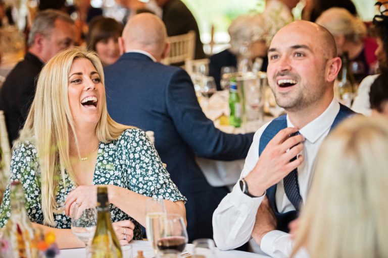 Wedding guests laughing.