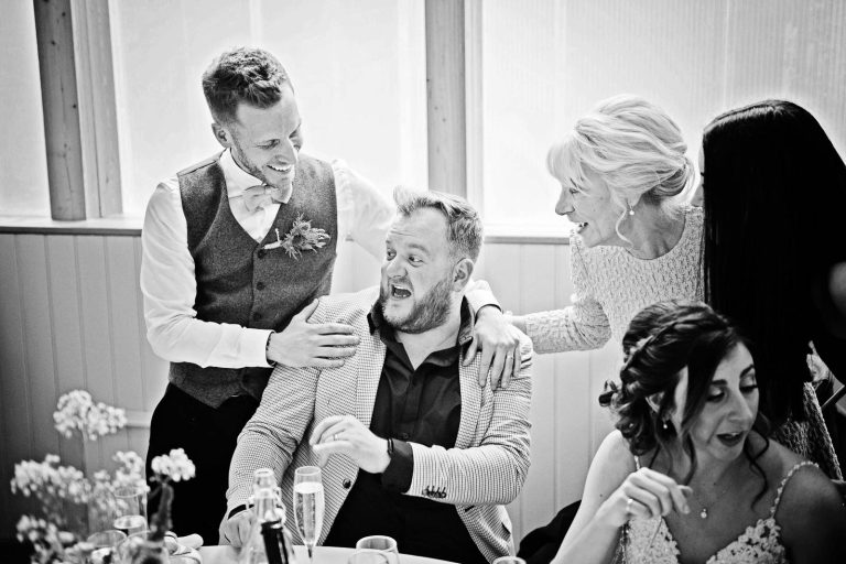 Story telling image of groom and mother of the groom checking to see if the guest is ok after lots of alcohol!