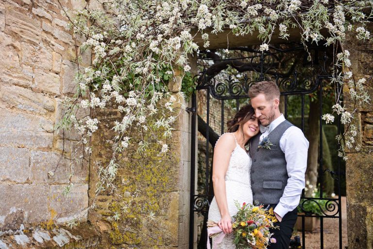 Bride and groom grab a moment together in between rain breaks.