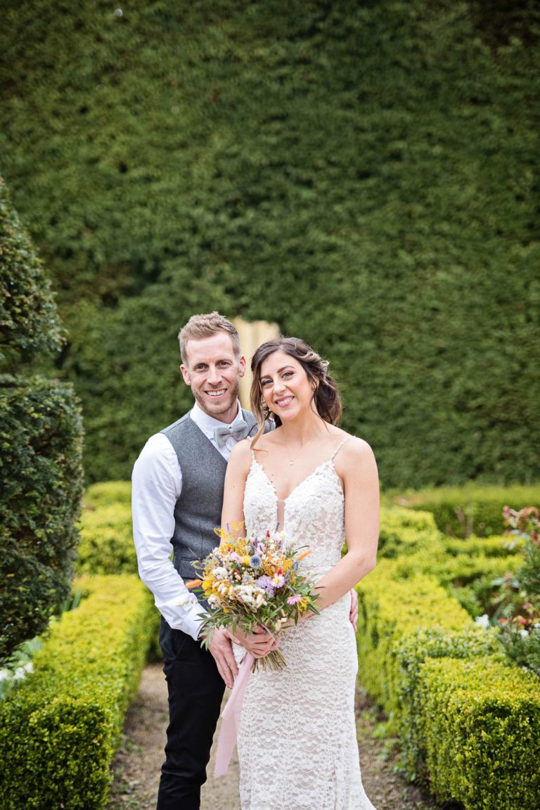 Portrait photo of bride and groom in the gardens at Owlpen Manor.