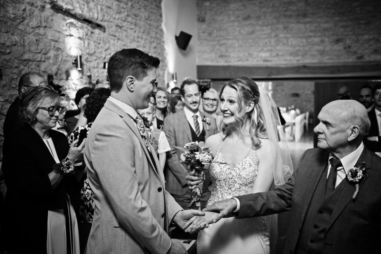 B&W storytelling photo of father of the bride giving his daughter away.