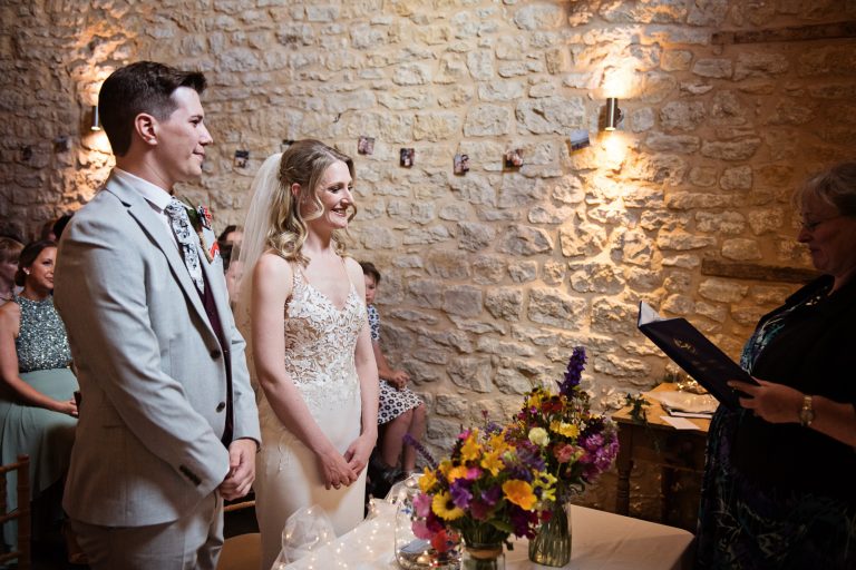 Documentary photo of bride and groom during their wedding ceremony.
