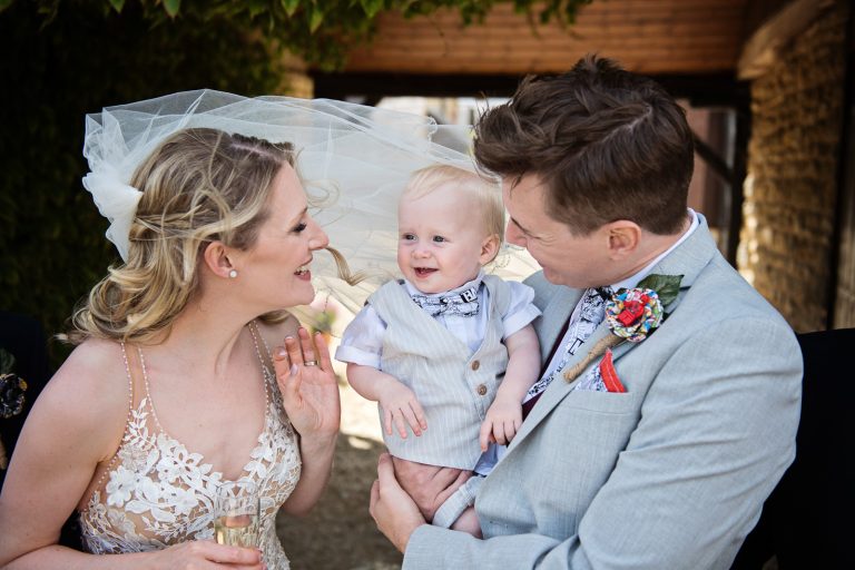 Bride and groom with their son on their wedding day.