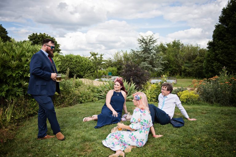 Relaxed wedding photography - guests chatting.