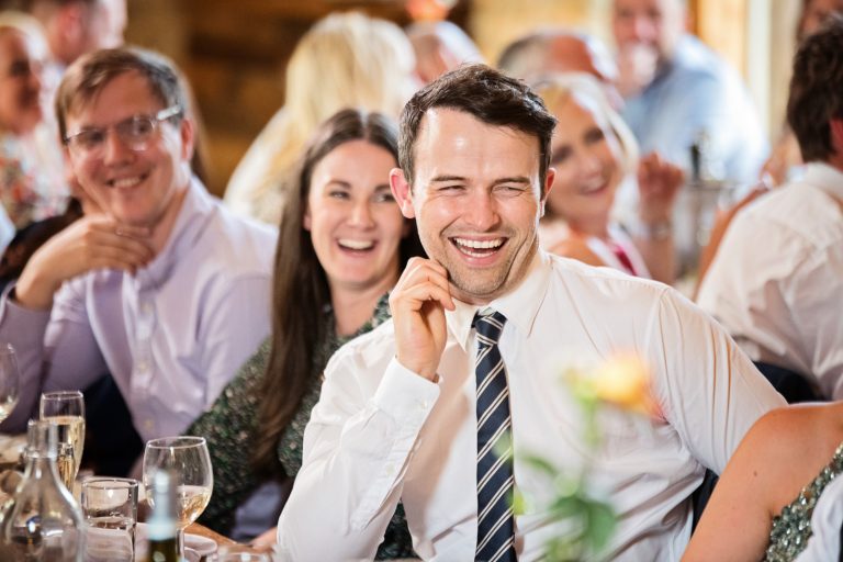 Wedding guest laughing at wedding speech)