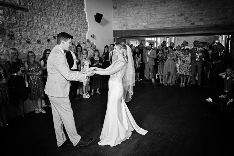 B&w photo of bride and groom doing their first dance.