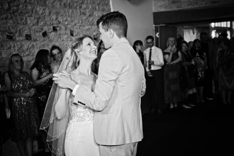 B&w photo of bride and groom doing their first dance.