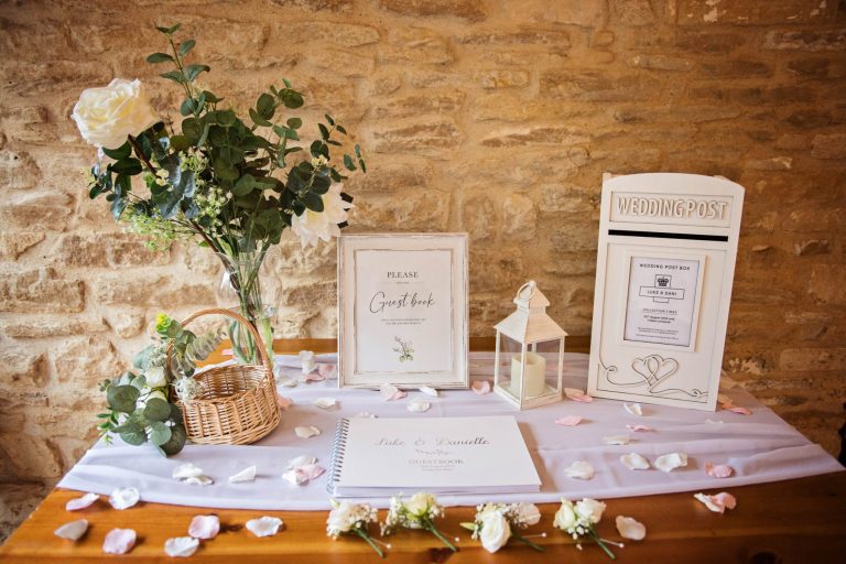 Wedding details at Kingscote Barn, including button holes and guest book.