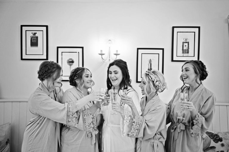 Unposed photo of Bridal Team celebrating wedding at Kingscote Barn