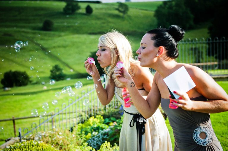 Blowing bubbles at Cotswold wedding venue, Kingscote Barn