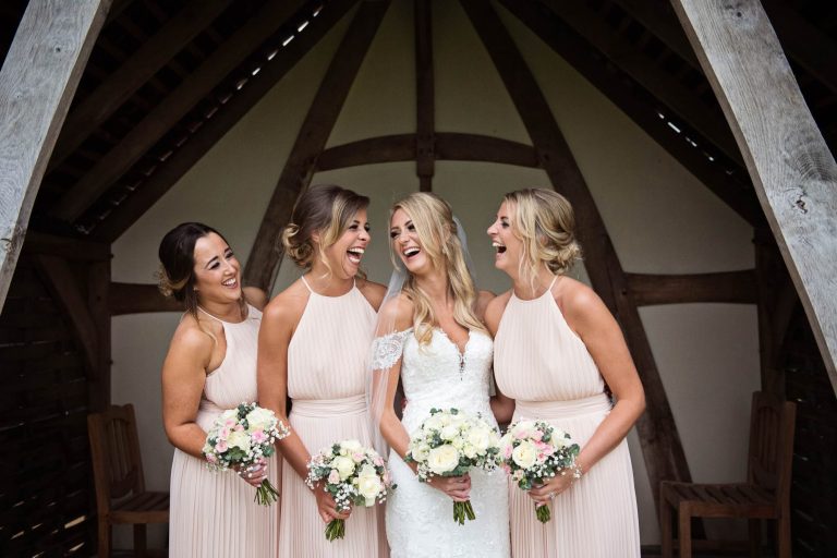 Bridal party laughing naturally candid photos by Blooming Photography
