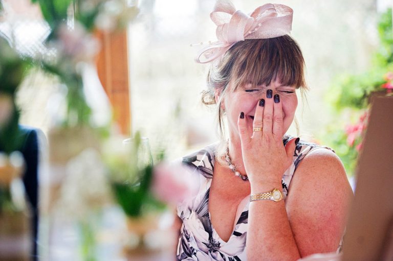 Candid photo by Blooming Photography at Kingscote Barn