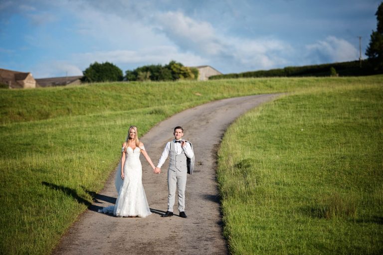 Gorgeous countryside at Kingscote Barn and wedding couple