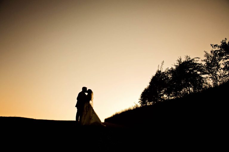 Silhouette of bride and groom at Kingscote Barn