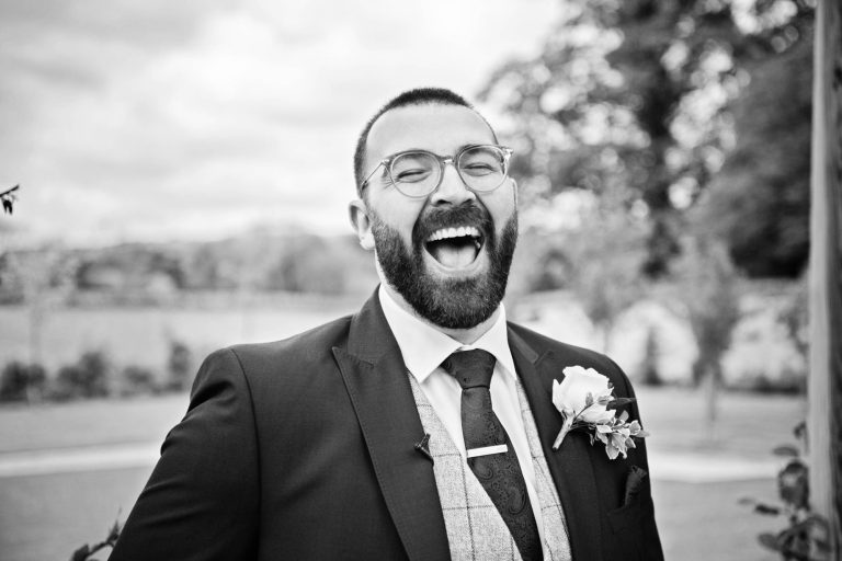 Groom laughing out loud.