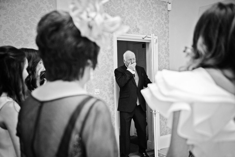 Candid photo of the father of the bride getting emotional as he see's his daughter for the first time at Syrencot.