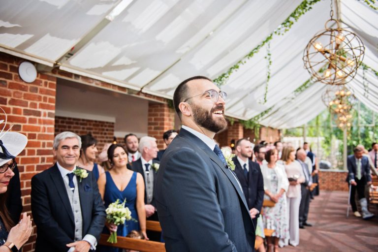 Groom taking a glimpse of his bride.