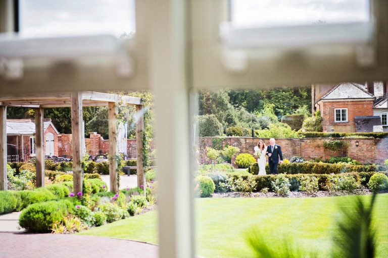 Looking through the window of bride and the father of the bride as they approach the wedding ceremony.