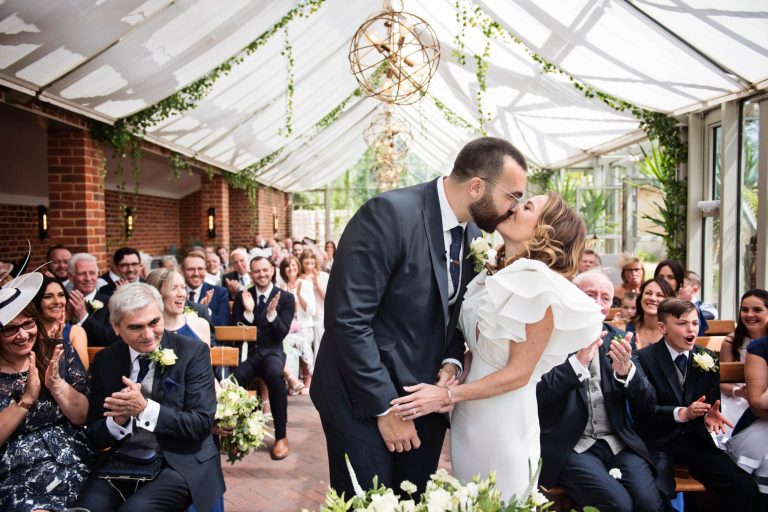 Bride and groom kiss after being announced husband and wife during their wedding ceremony at Syrencot.