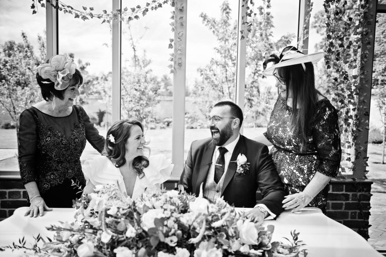 B&W candid photo of bride and groom with their witness'.
