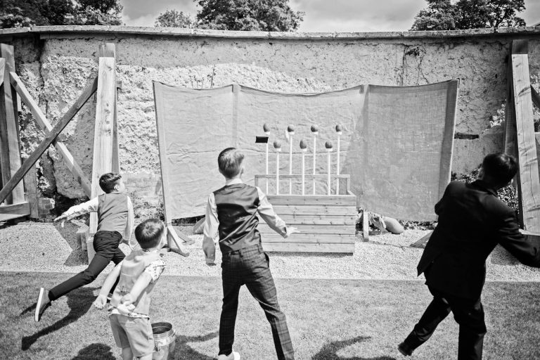 Candid B&W photo of kids playing on the coconut sty at Syrencot.