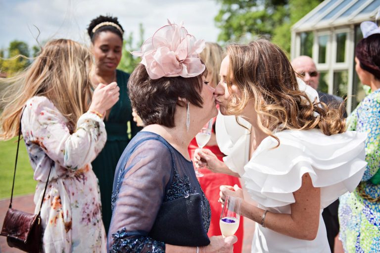 Candid photo of bride kissing her grandma.