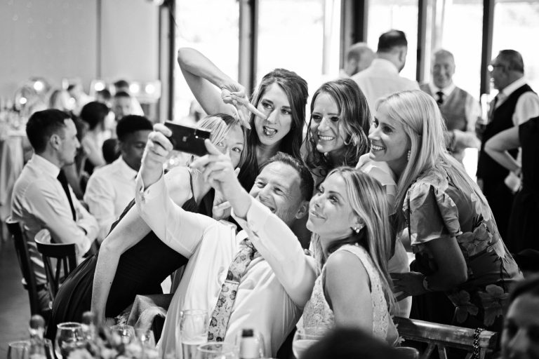 B&W selfie by wedding guests.
