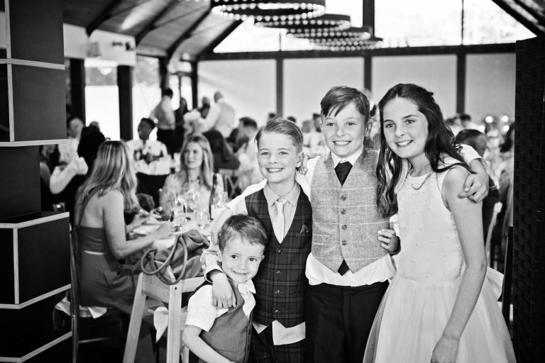 Candid photo of kids during the wedding breakfast. B&W image.