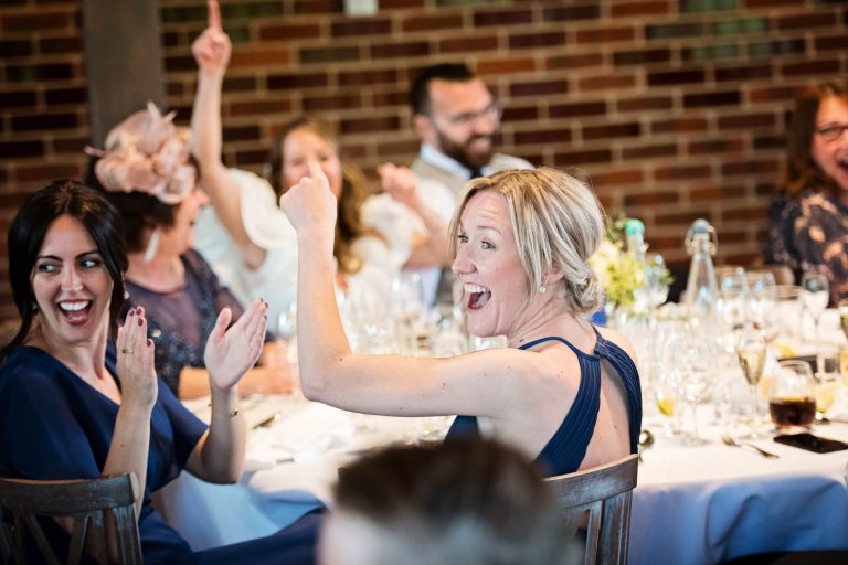 Wedding guest listening to wedding speeches.
