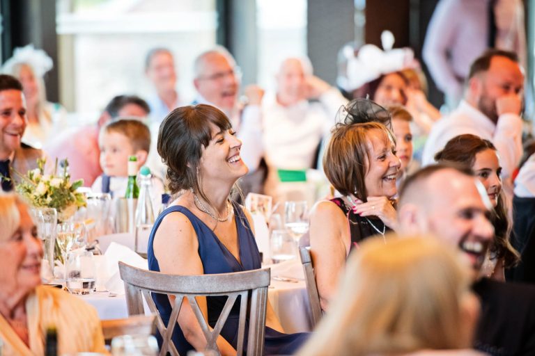 Wedding guest listening to wedding speeches.